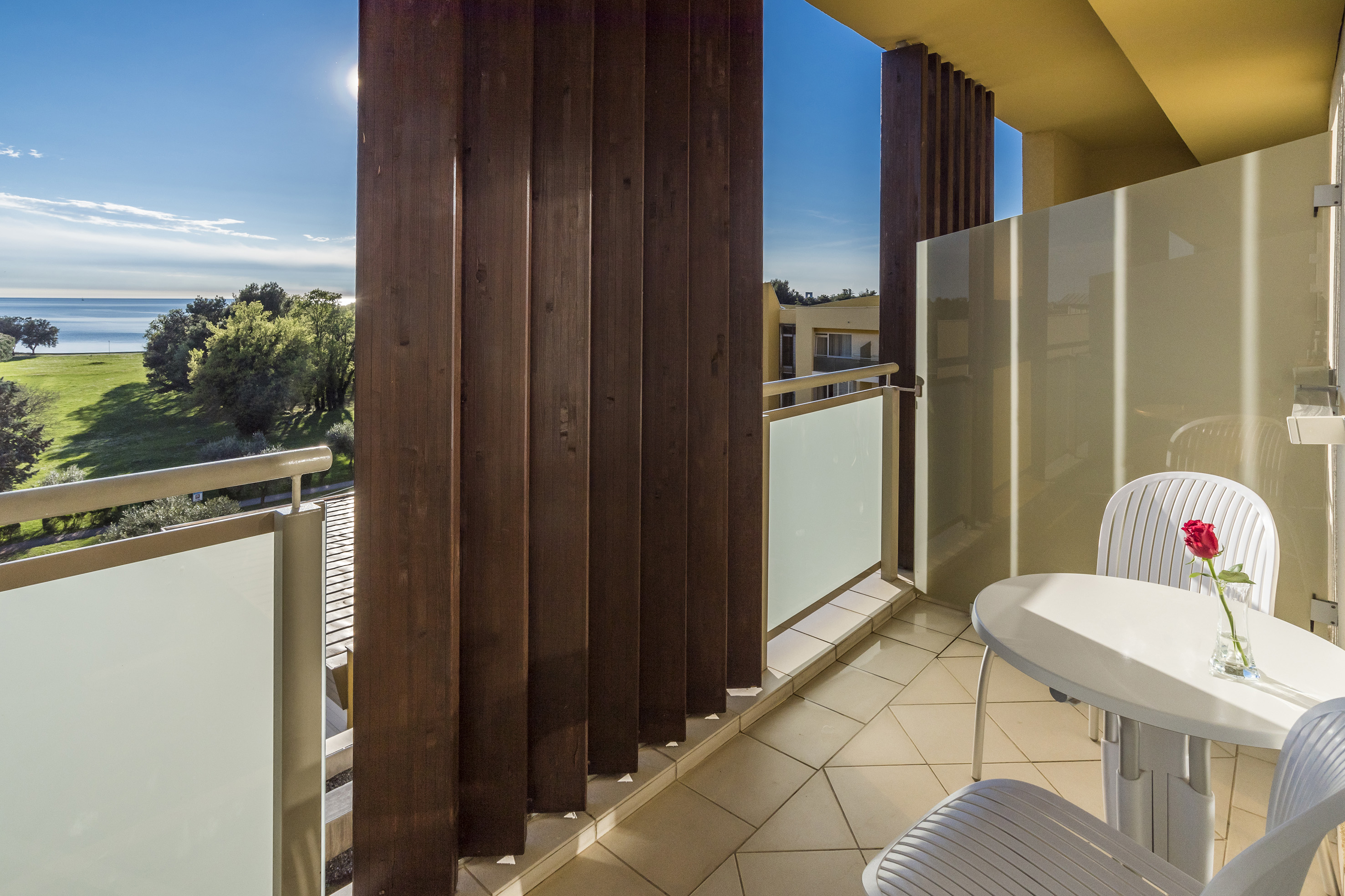 a balcony with a table and chairs