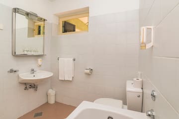 a bathroom with a sink toilet and toilet paper