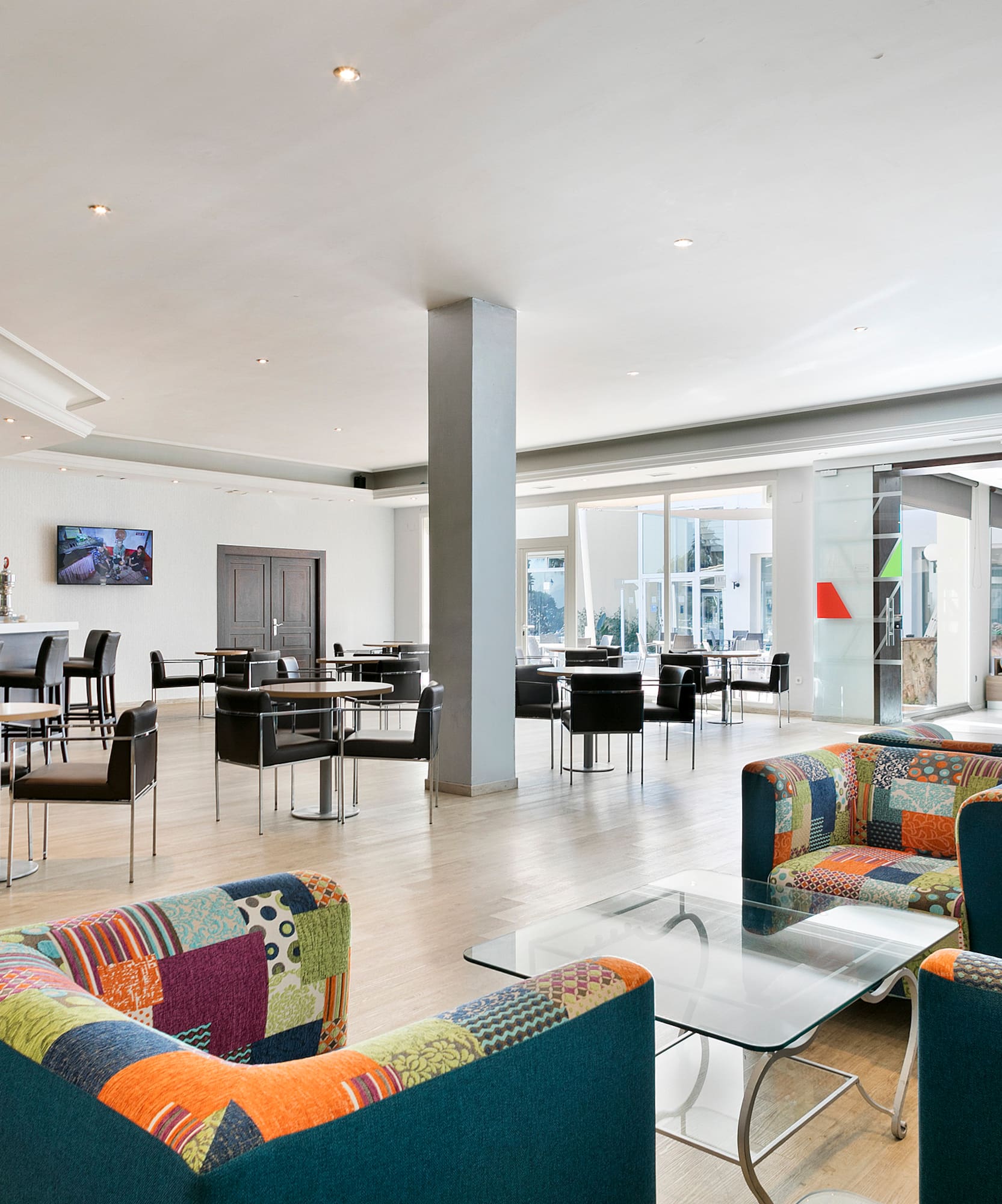 a room with colorful chairs and tables