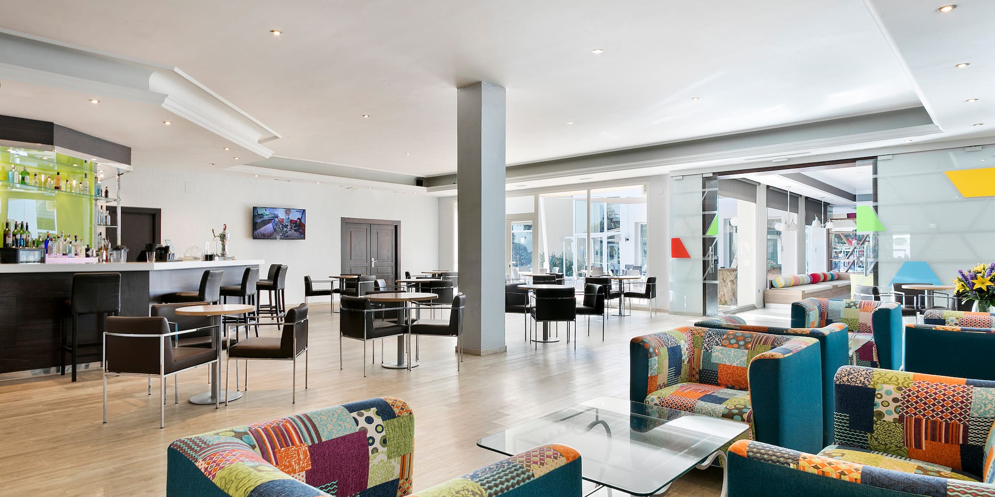 a room with colorful chairs and tables