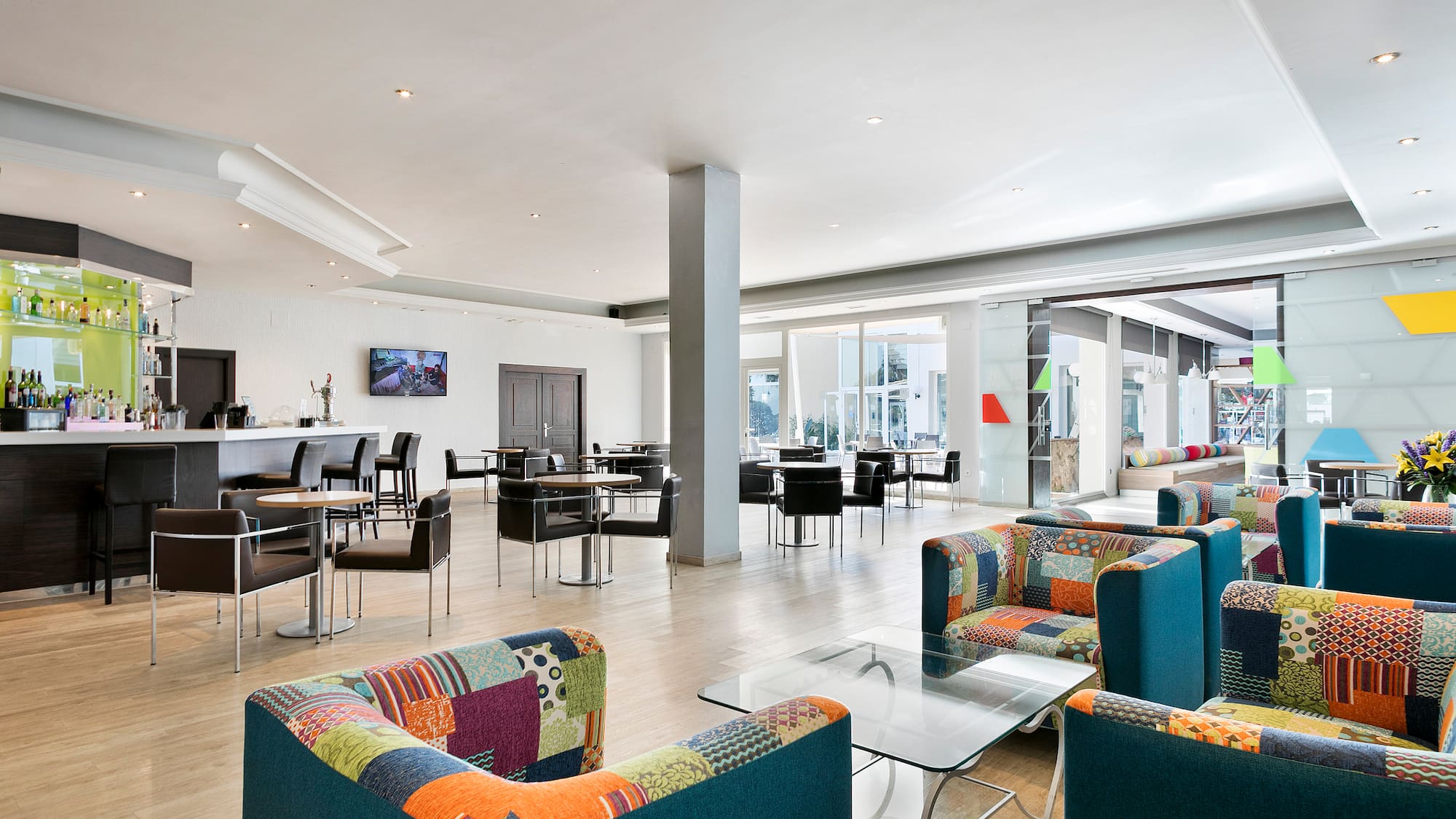 a room with colorful chairs and tables