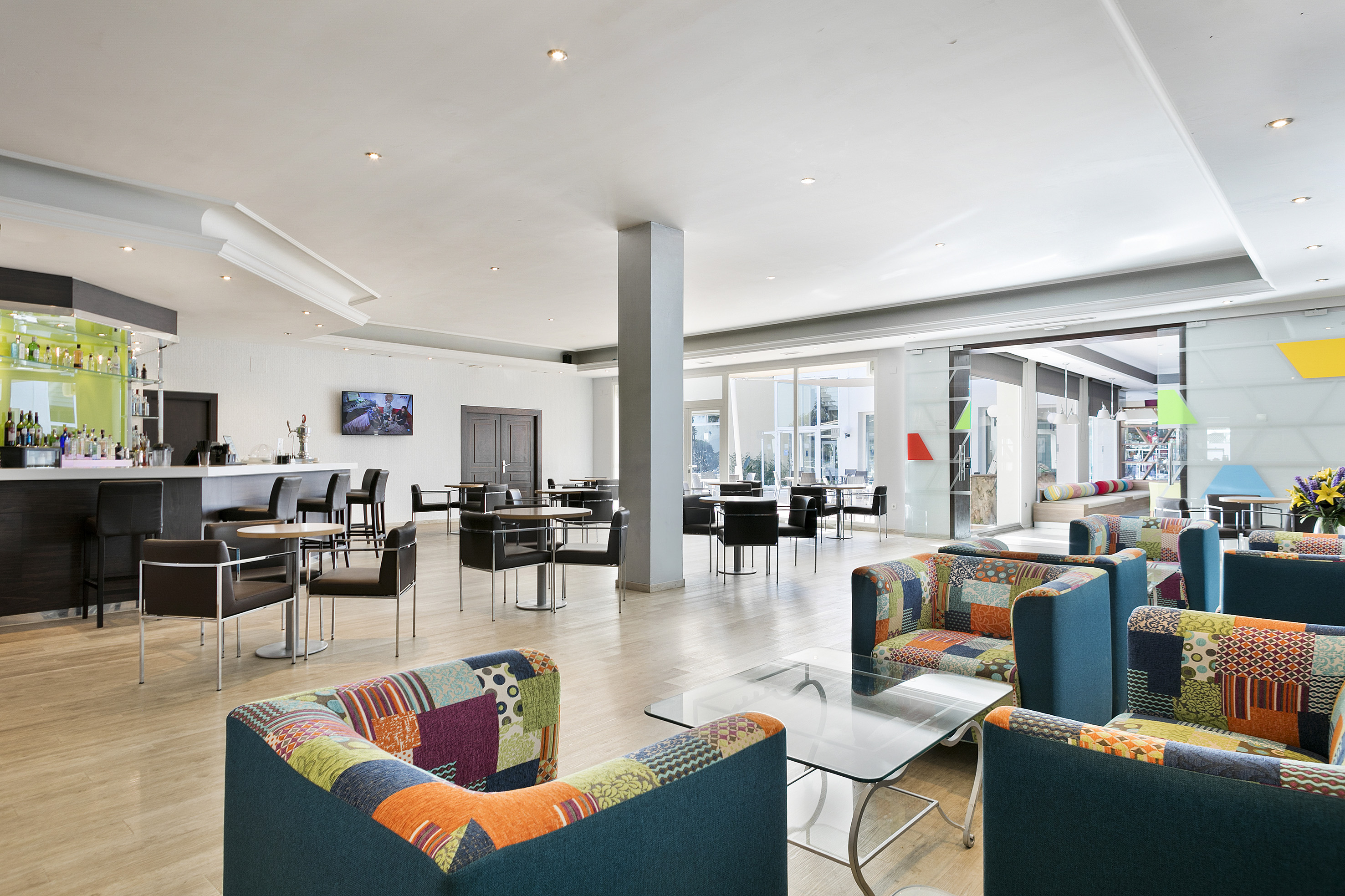 a room with colorful chairs and tables