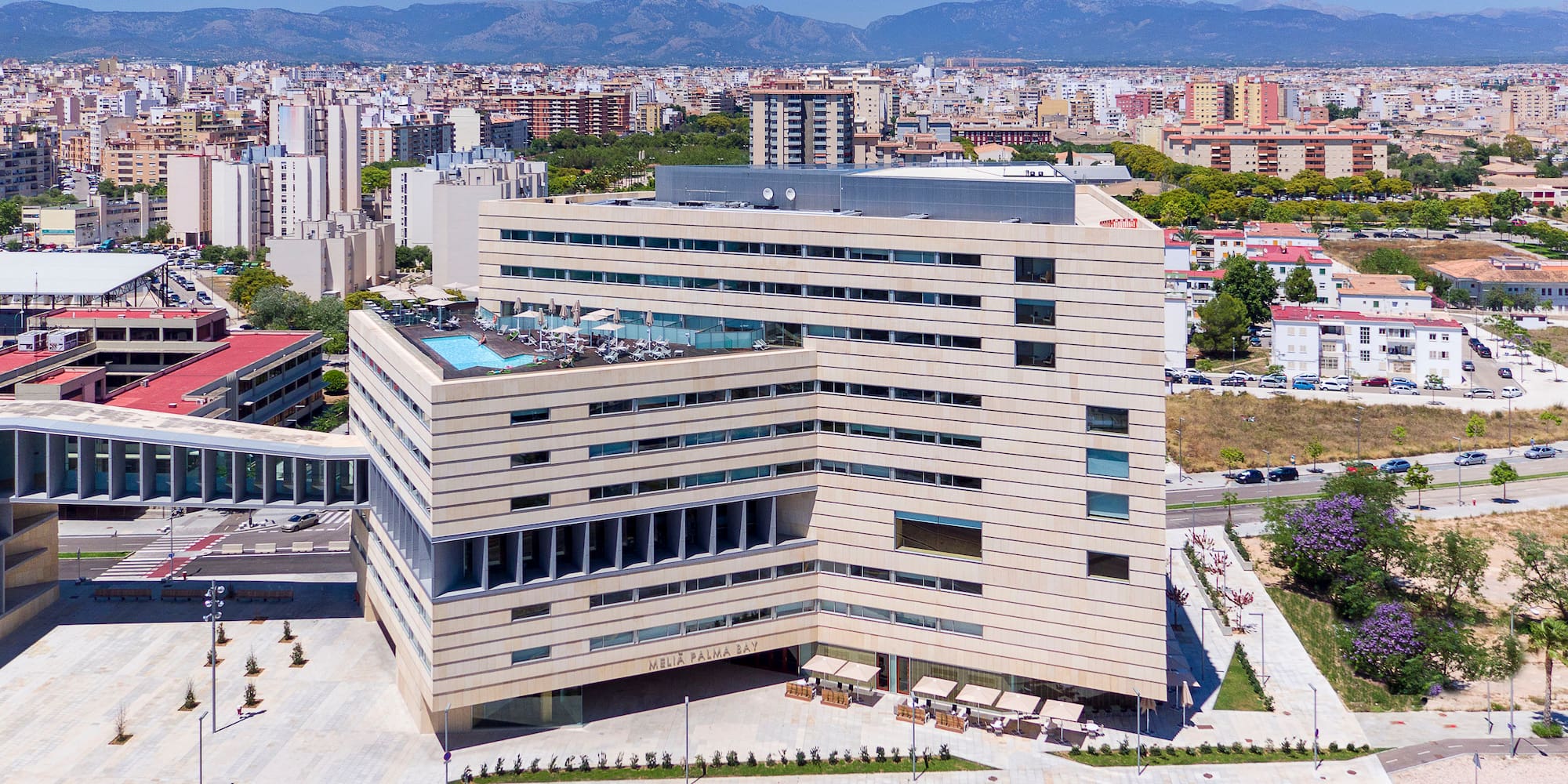 a large building with a parking lot and a road