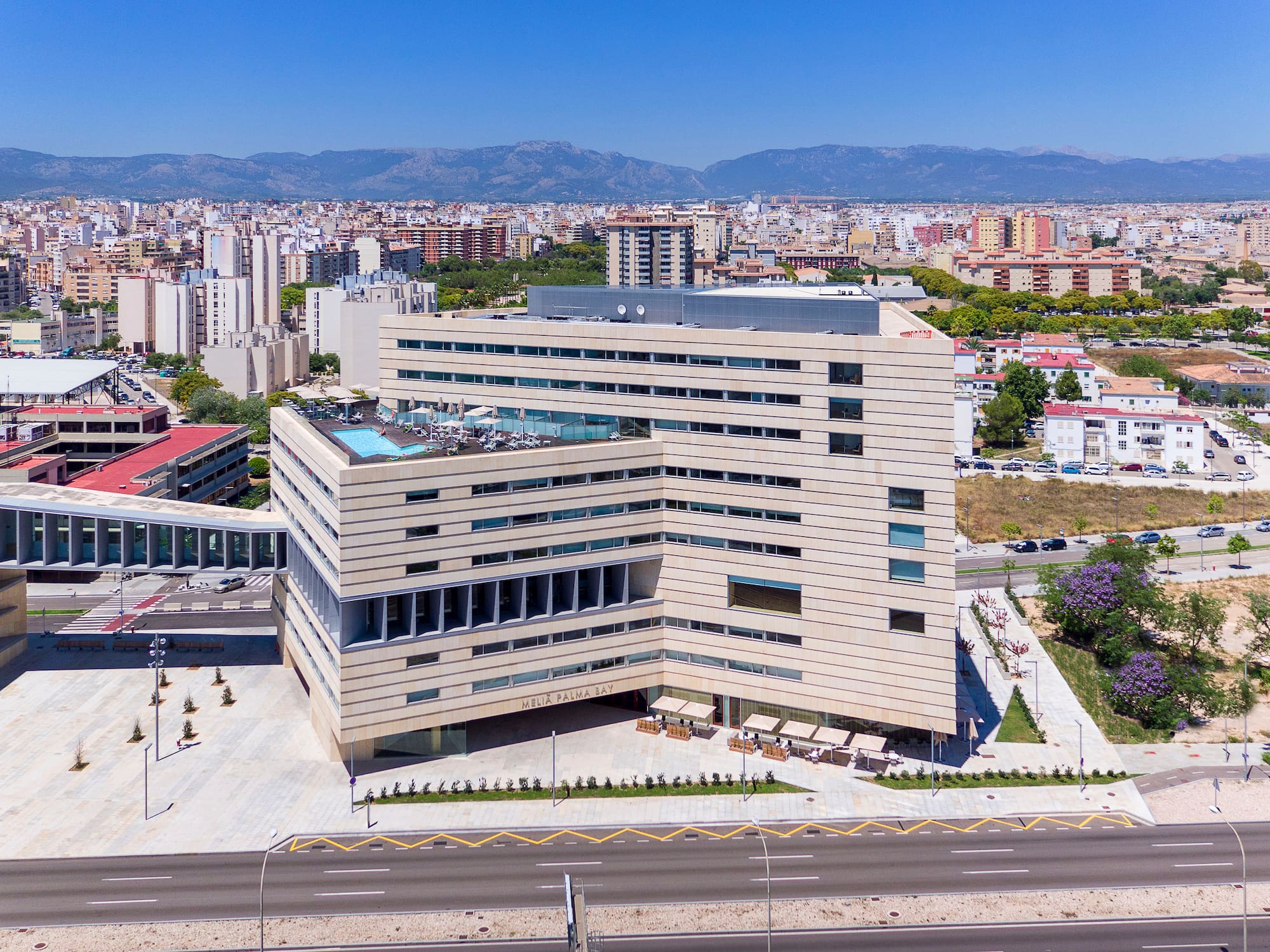 a large building with a parking lot and a road