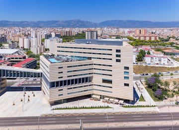 a large building with a parking lot and a road