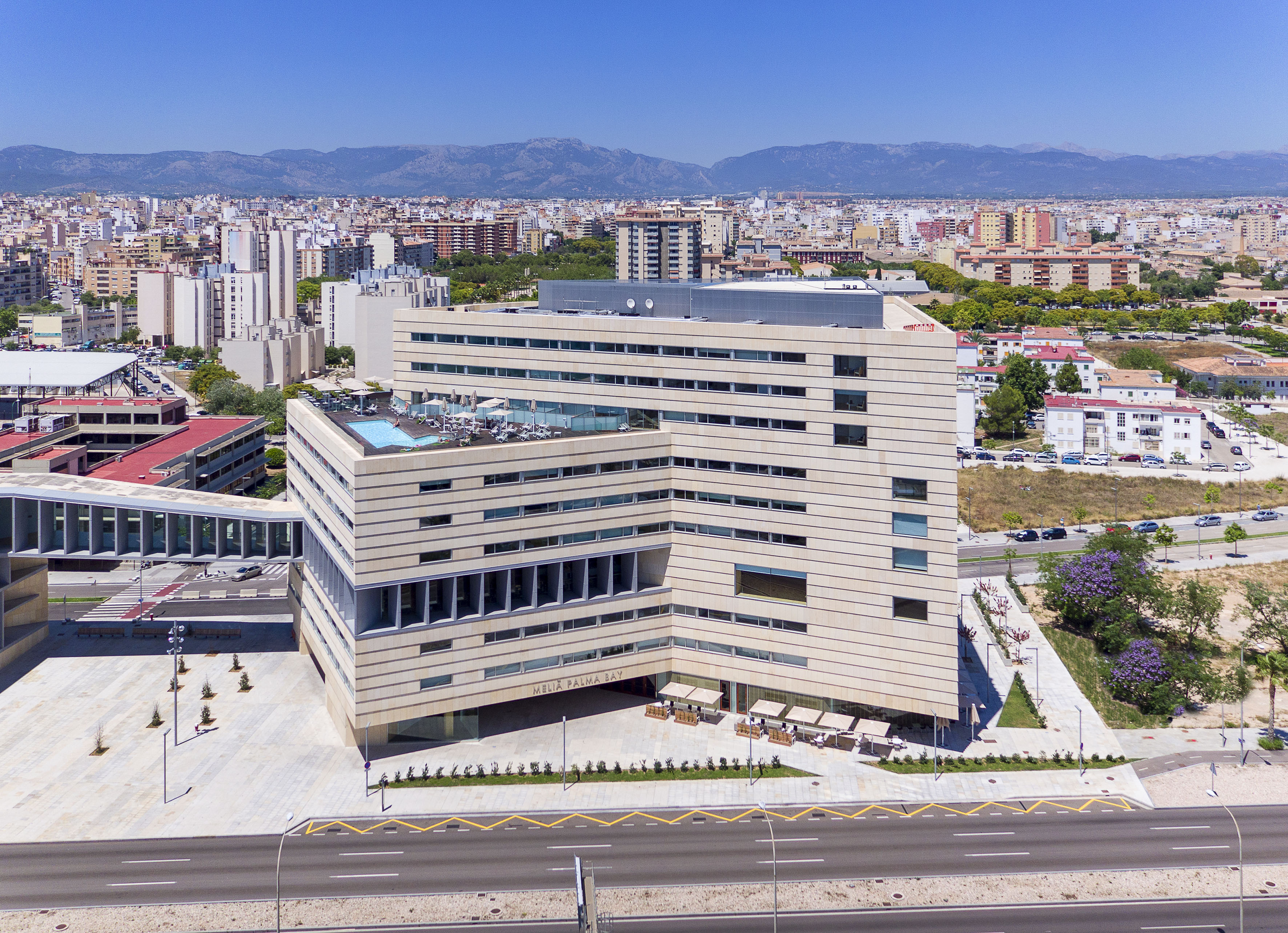a large building with a parking lot and a road