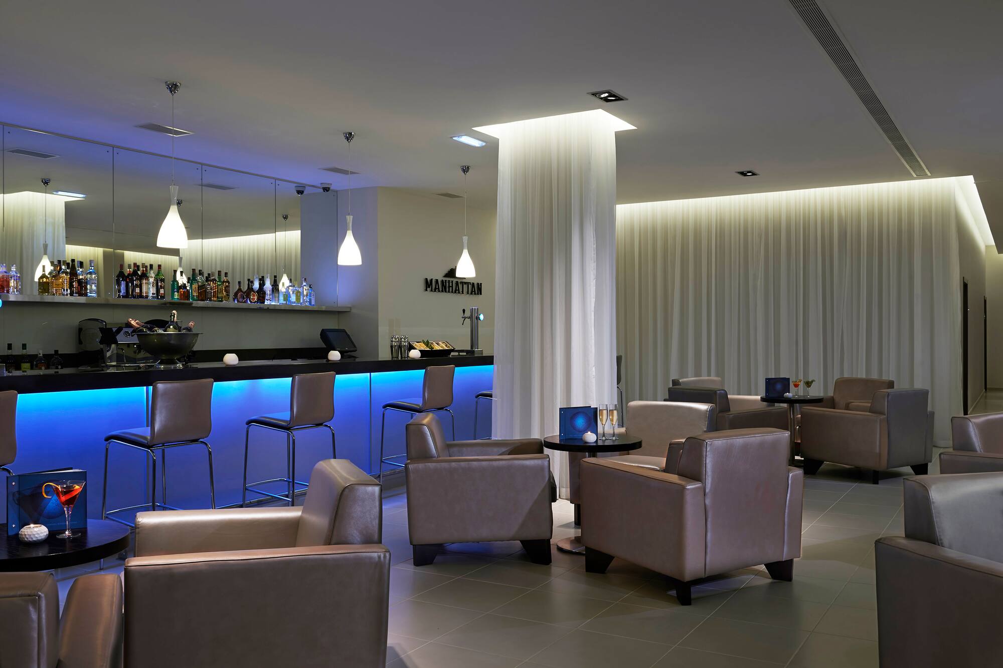 a room with chairs and a bar