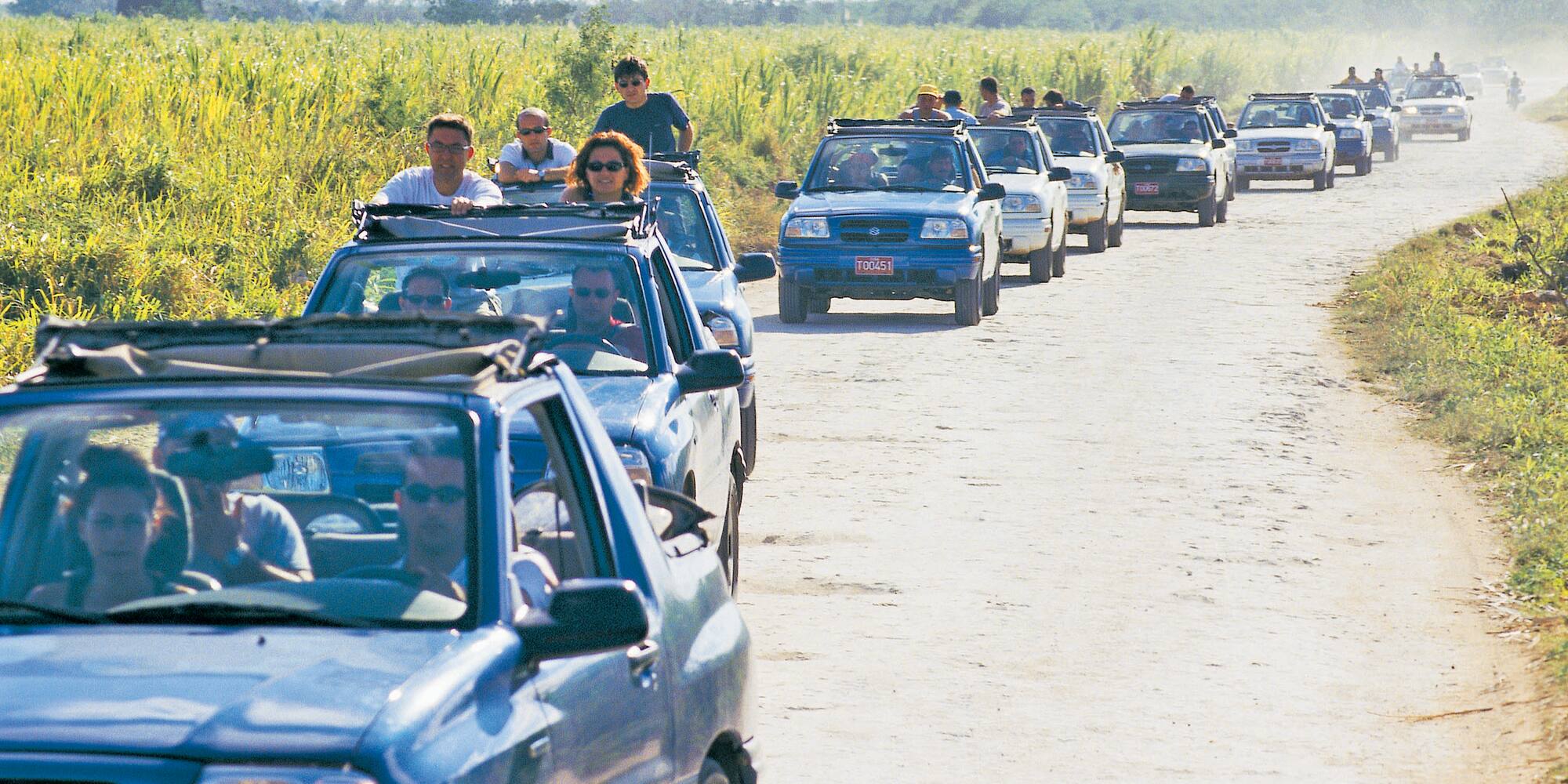 a group of people in a row of cars