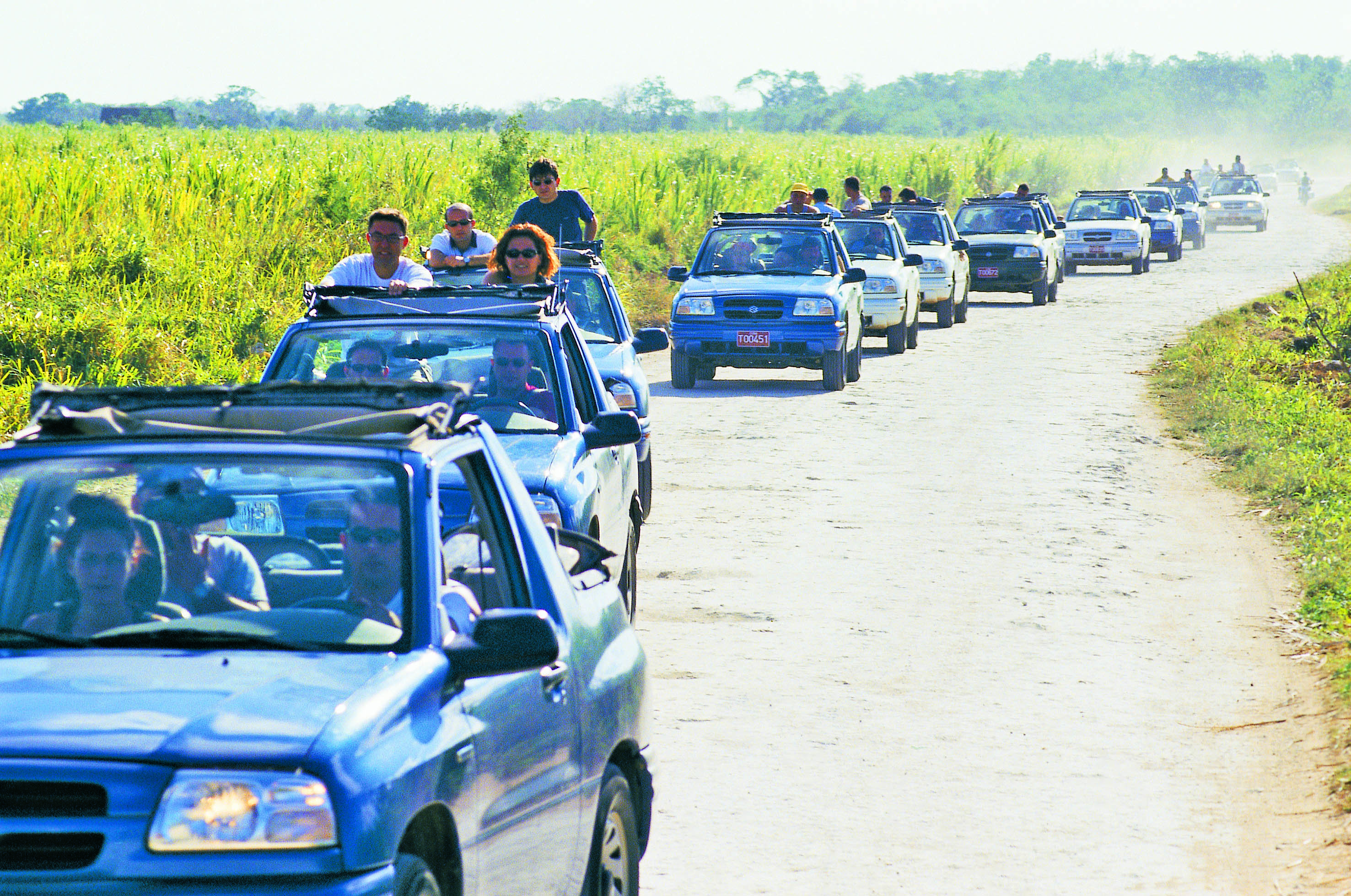 a group of people in a row of cars