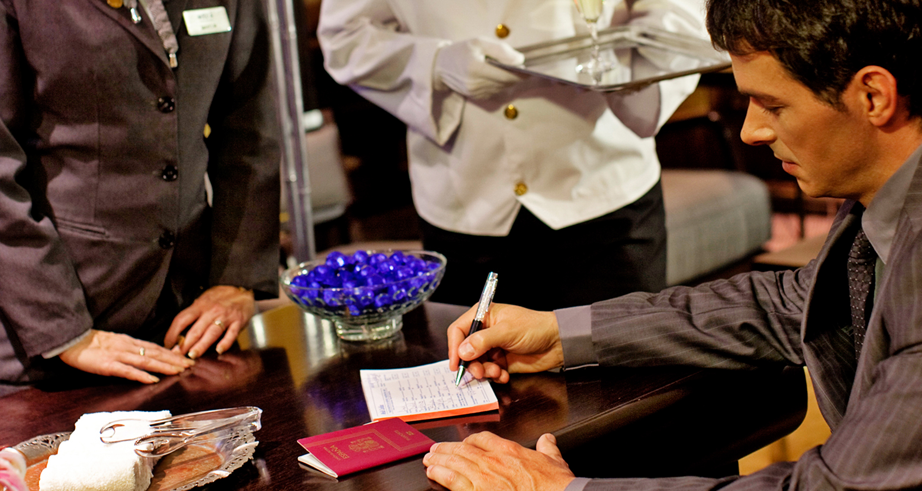 a waiter serving a guest to a guest