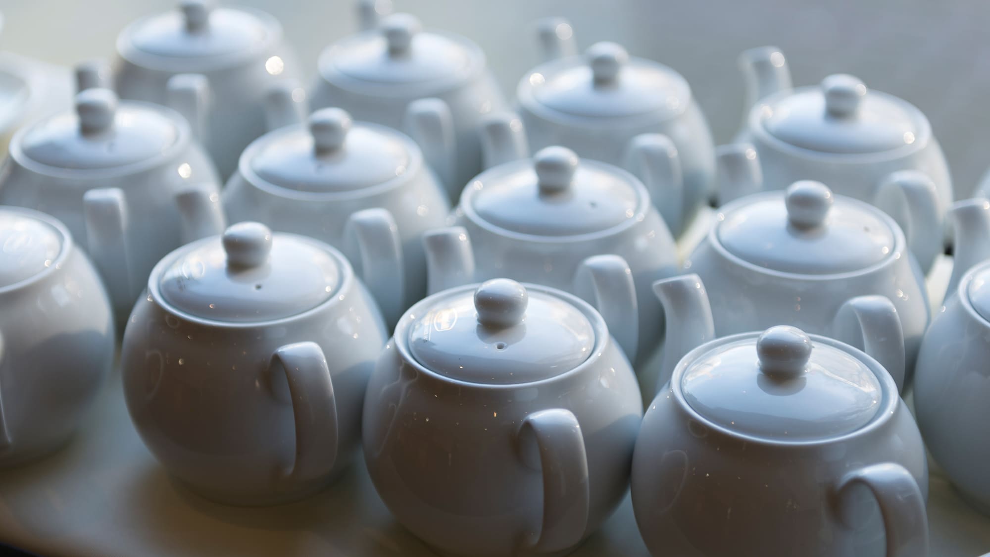 a group of white teapots