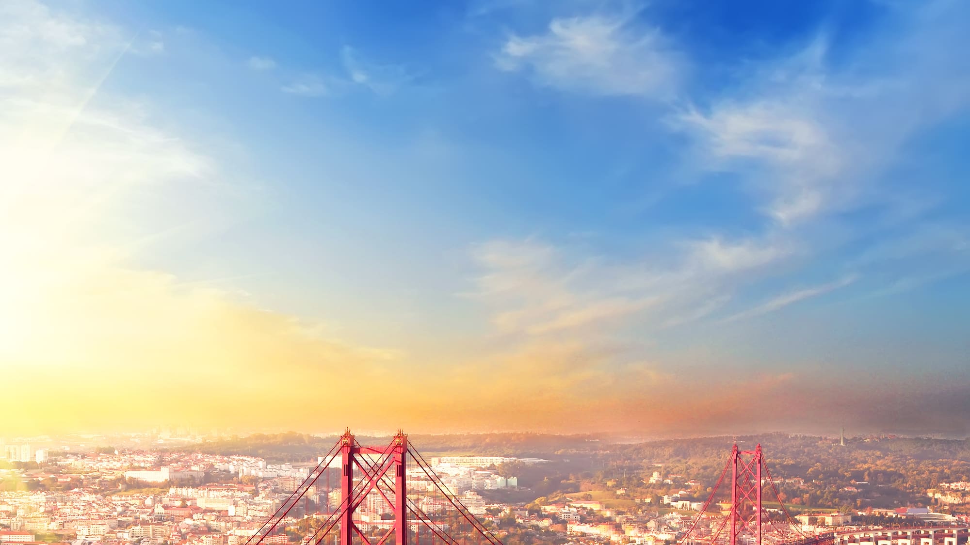 a bridge over water with a city in the background