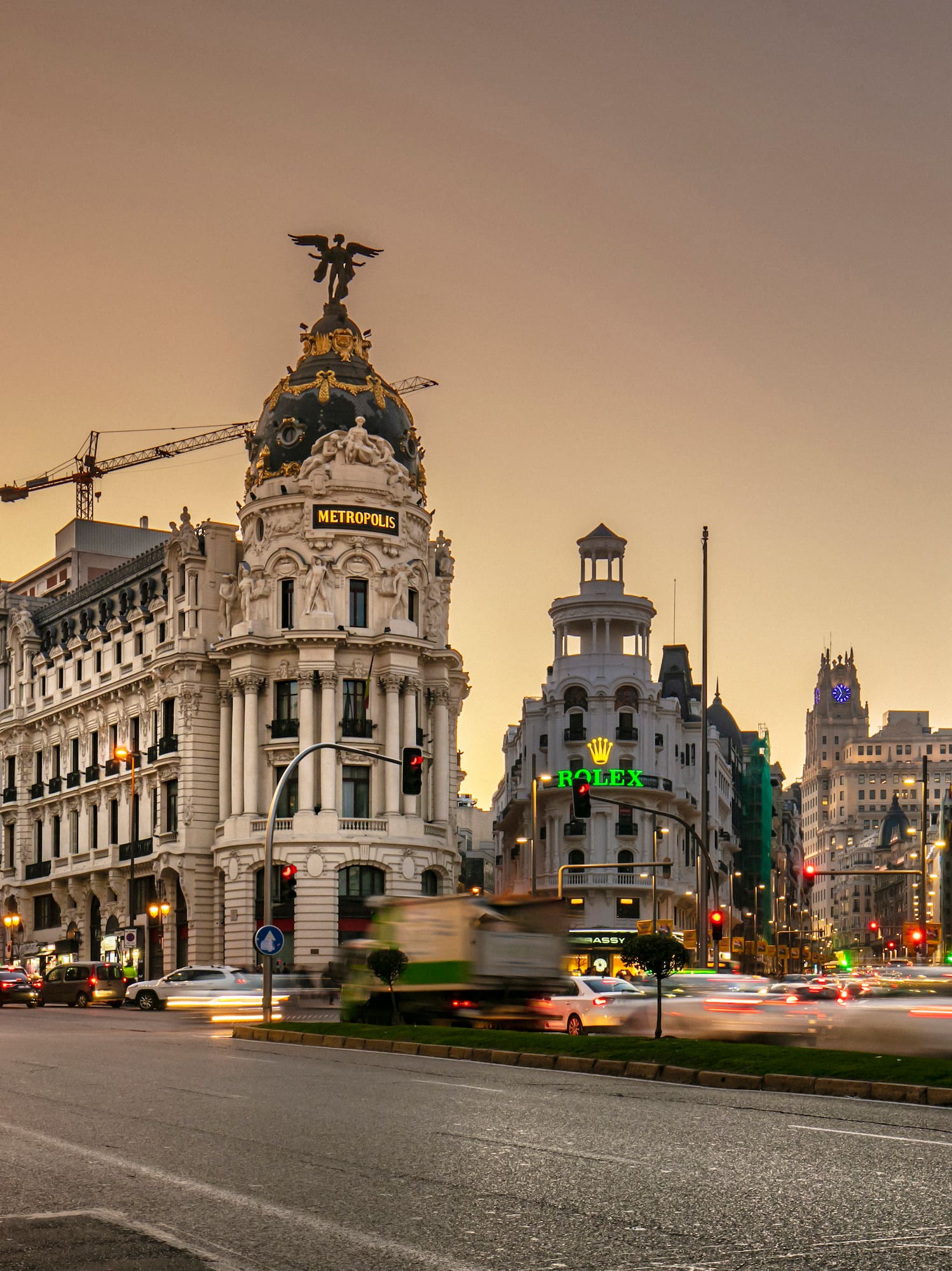 a street with cars and buildings in the background