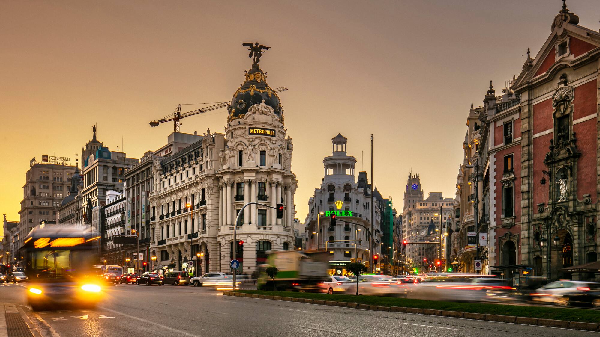a street with cars and buildings in the background