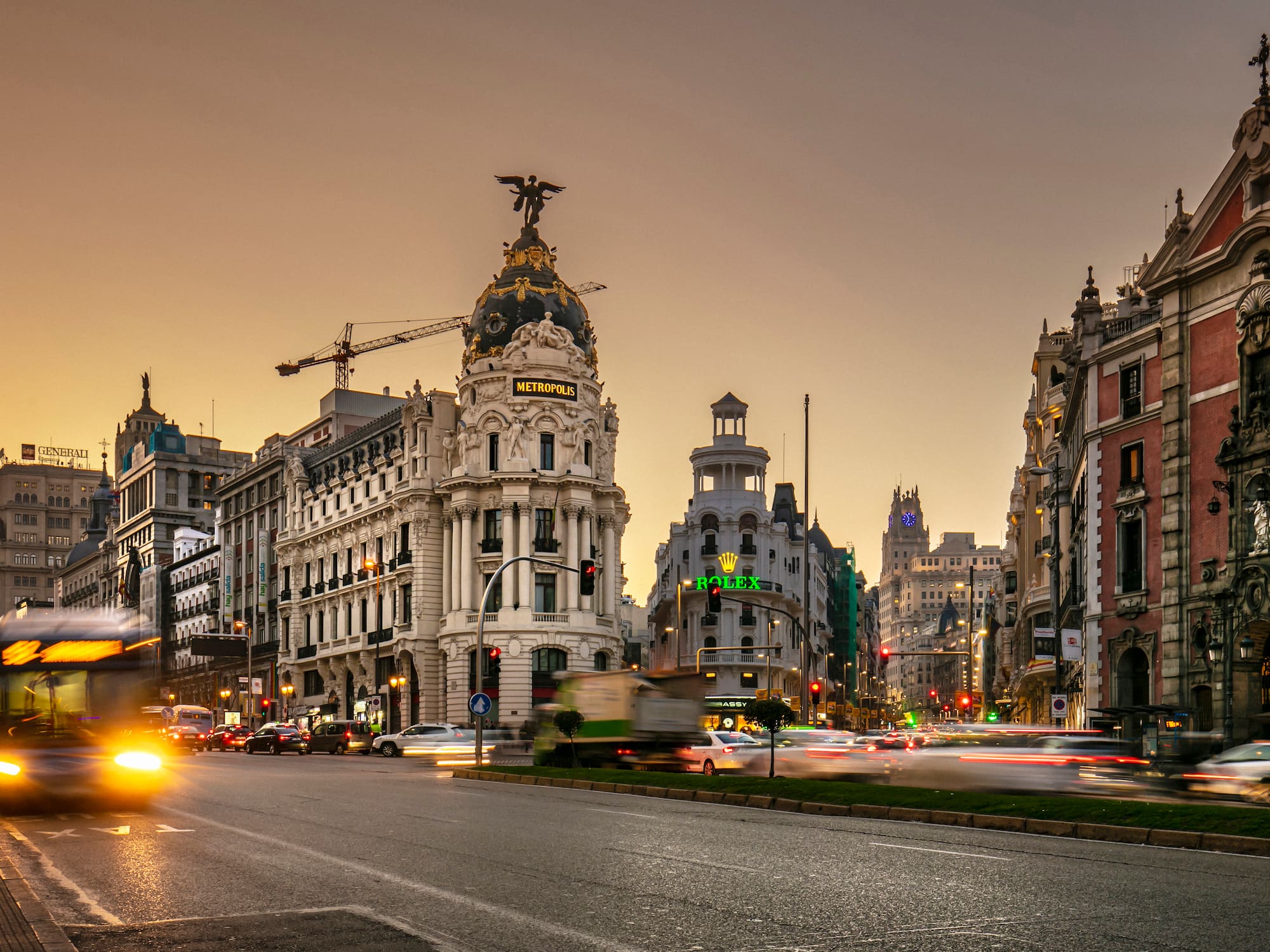 a street with cars and buildings in the background