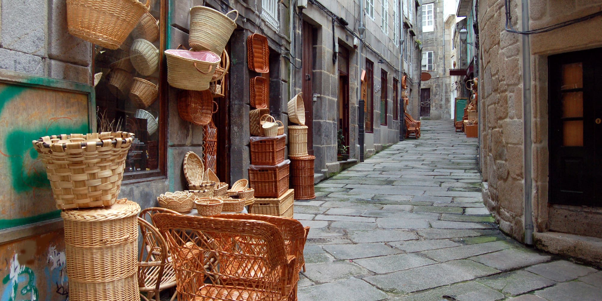 a street with wicker baskets and chairs