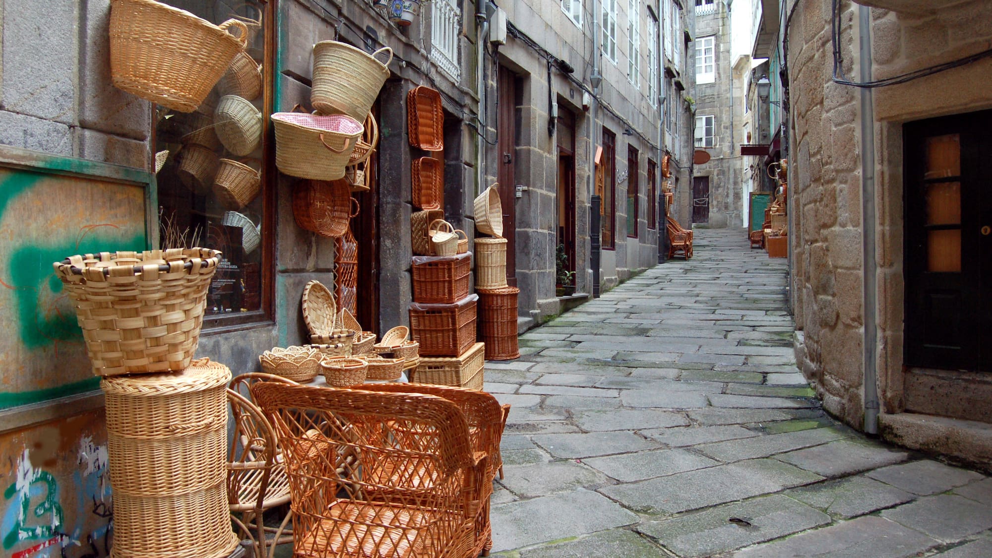 a street with wicker baskets and chairs