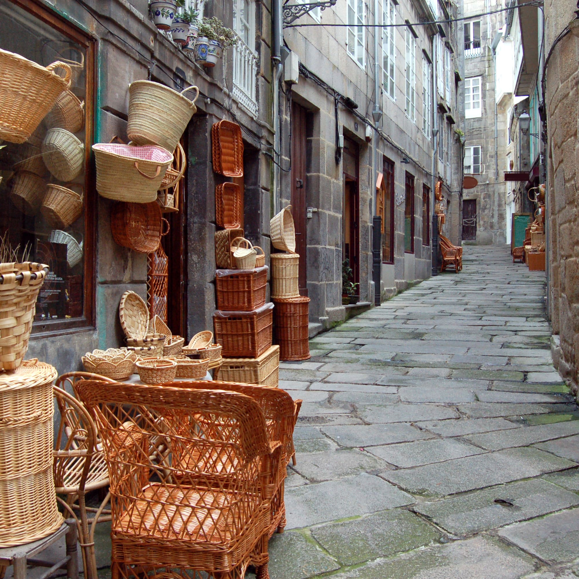 a street with wicker baskets and chairs