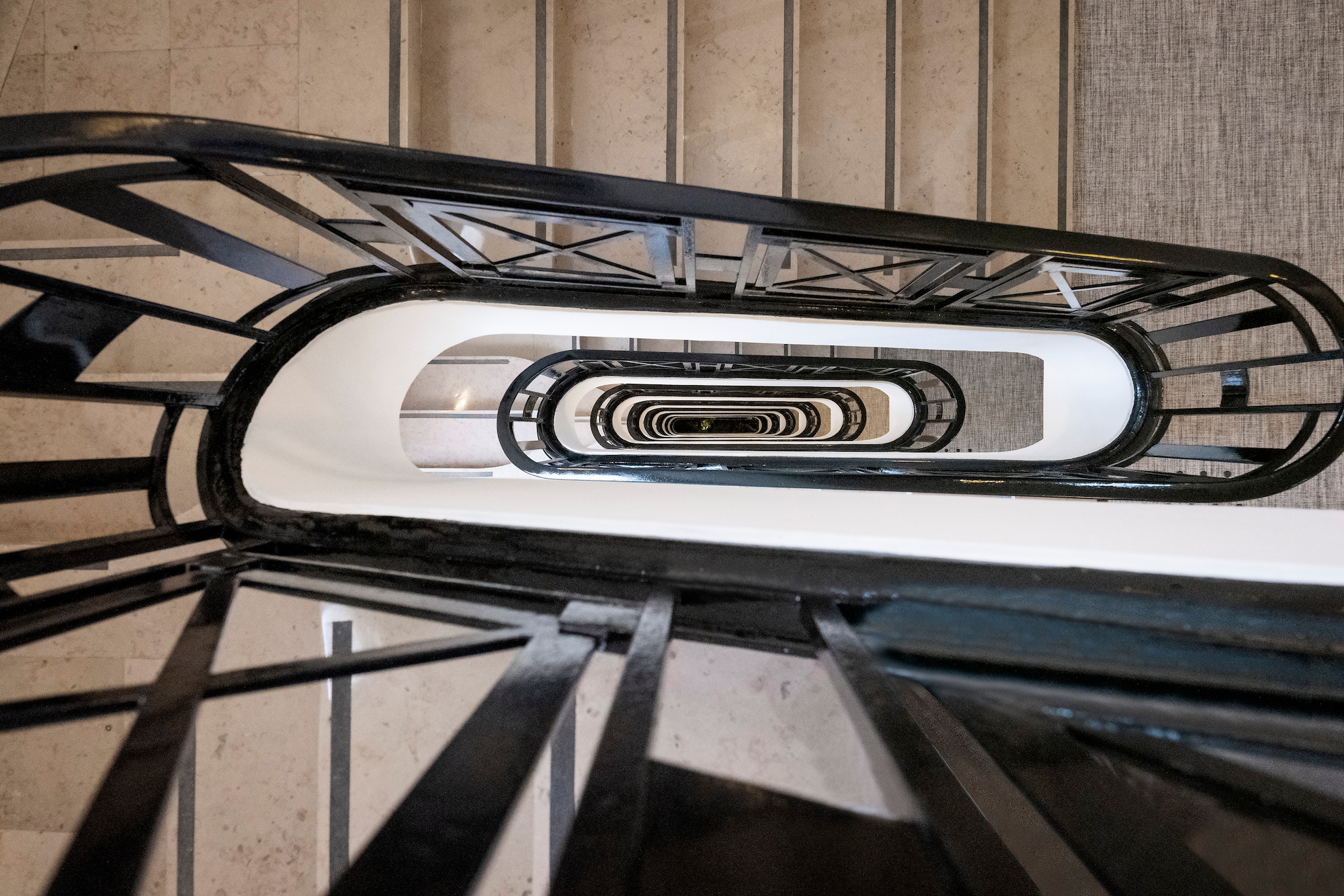 Overhead view: architectural black metal winding spiral staircase.