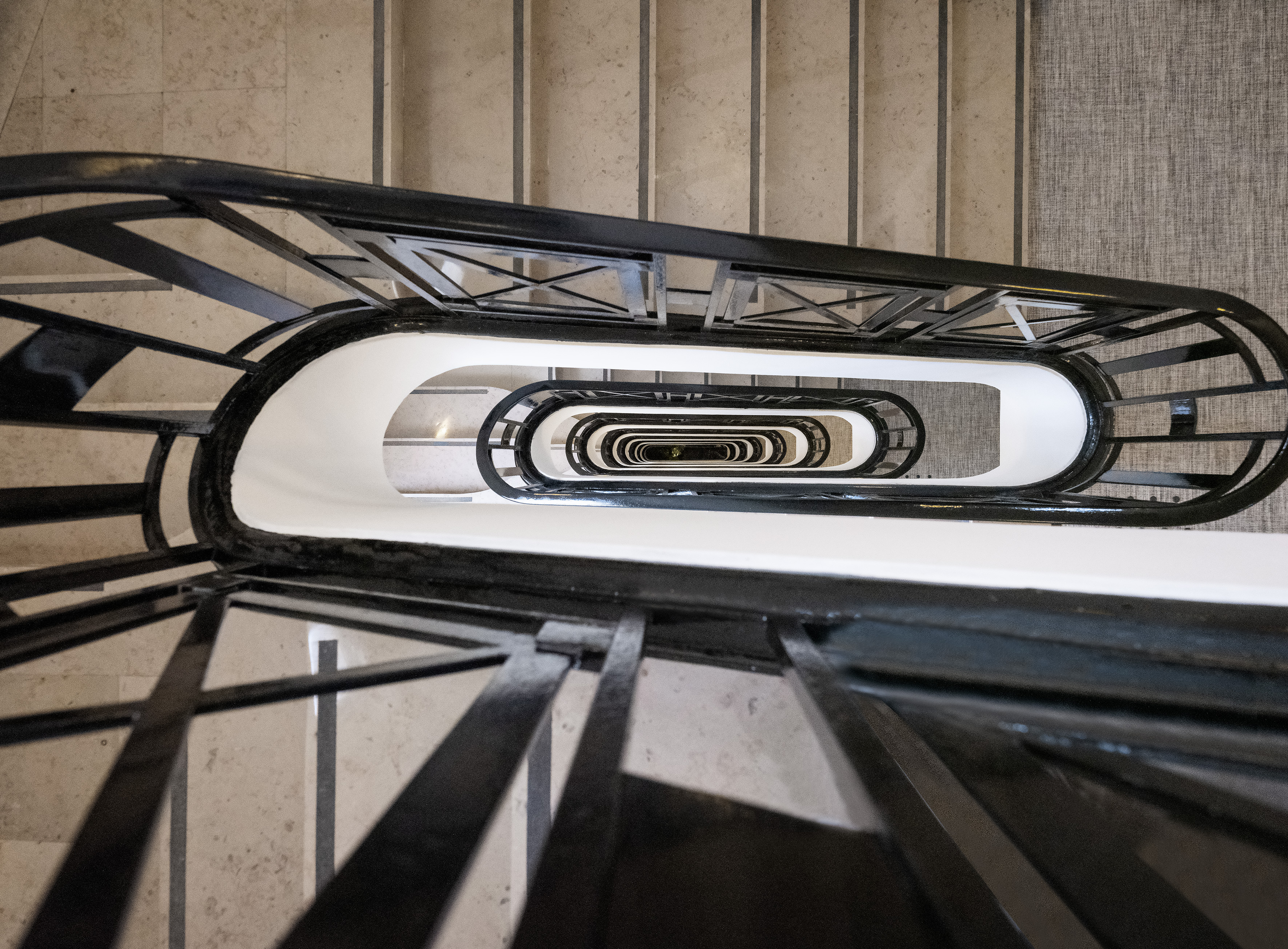 Overhead view: architectural black metal winding spiral staircase.