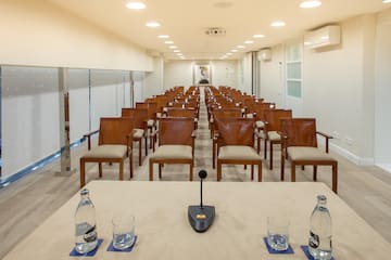 a conference room with chairs and a microphone