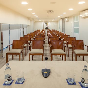 a conference room with chairs and a microphone