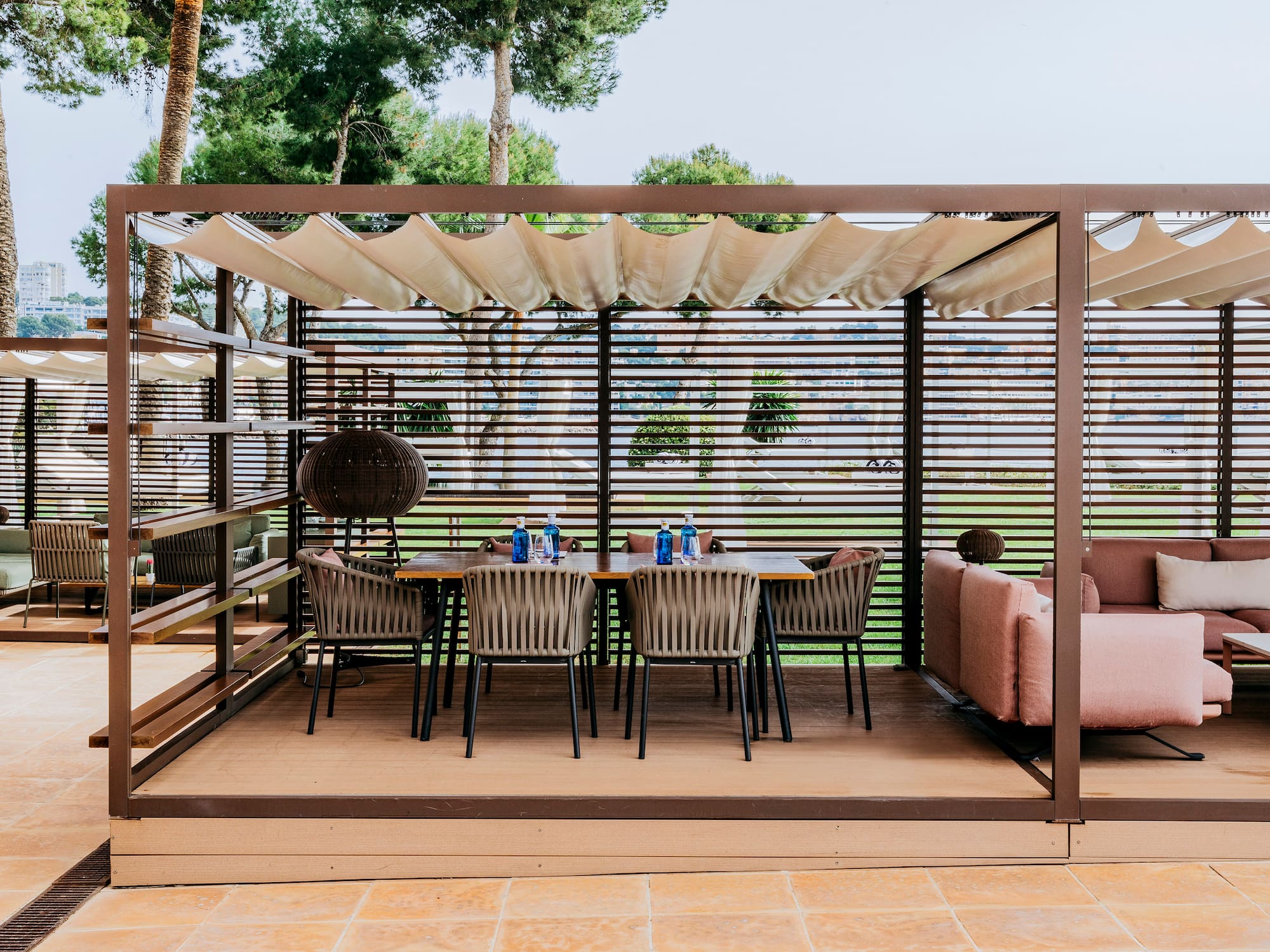 a table and chairs under a pergola