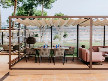 a table and chairs under a pergola
