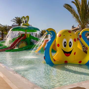 a water park with an inflatable octopus and a slide