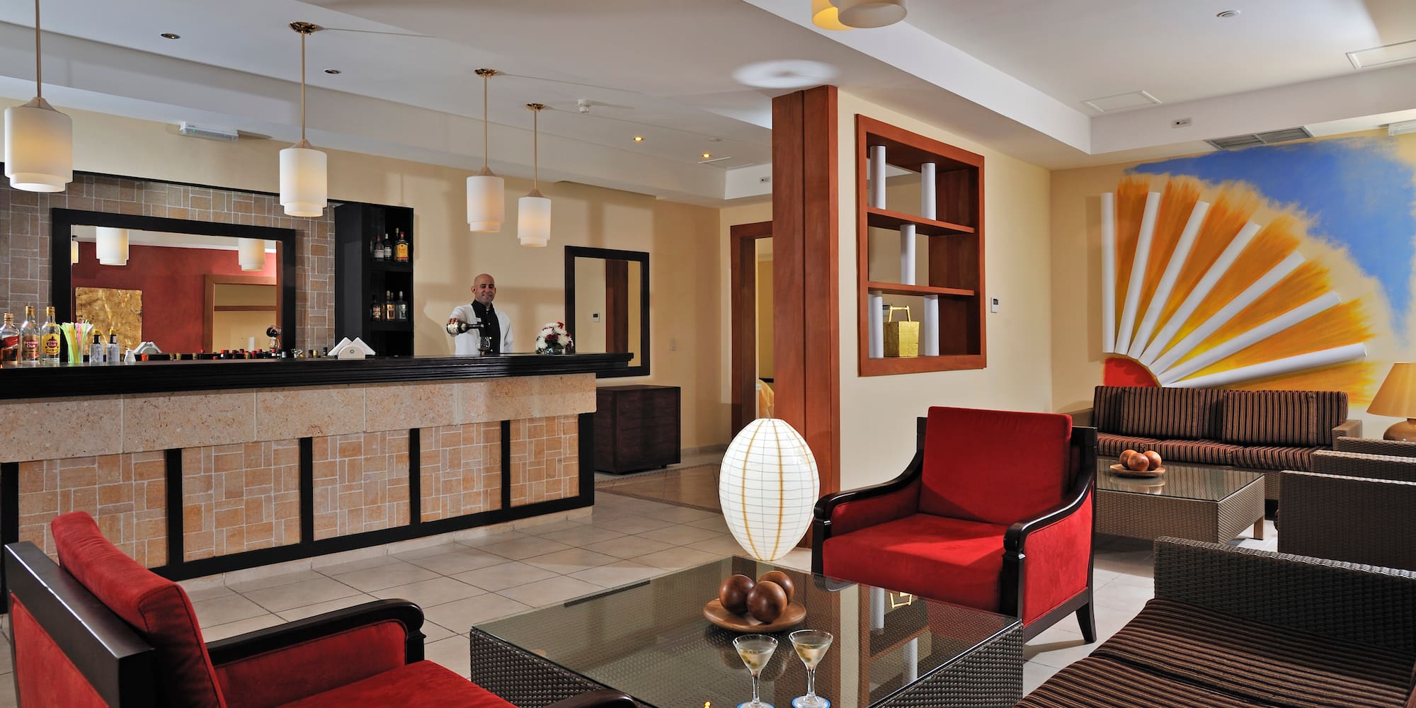 a hotel lobby with a man standing behind the counter