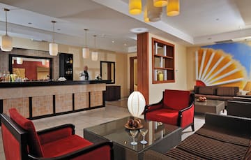 a hotel lobby with a man standing behind the counter