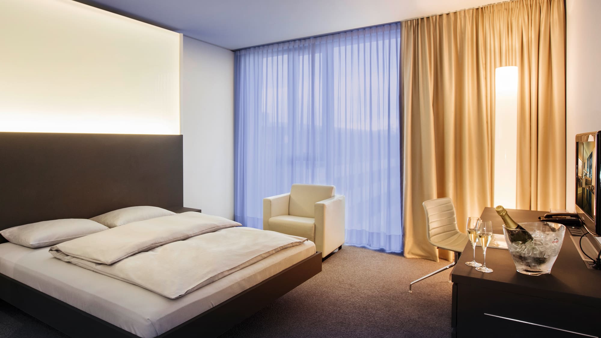 a bedroom with a bed and chair