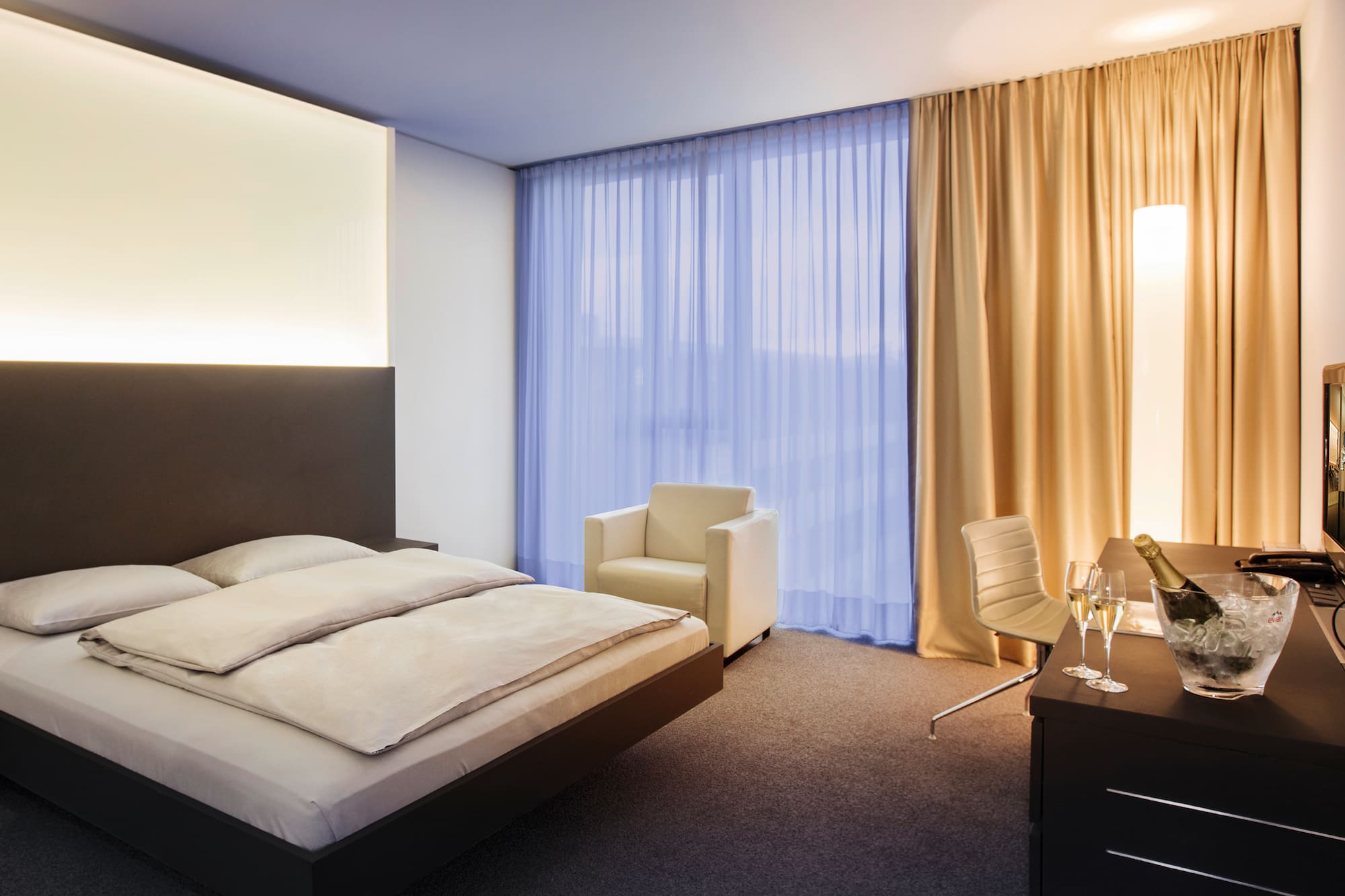 a bedroom with a bed and chair