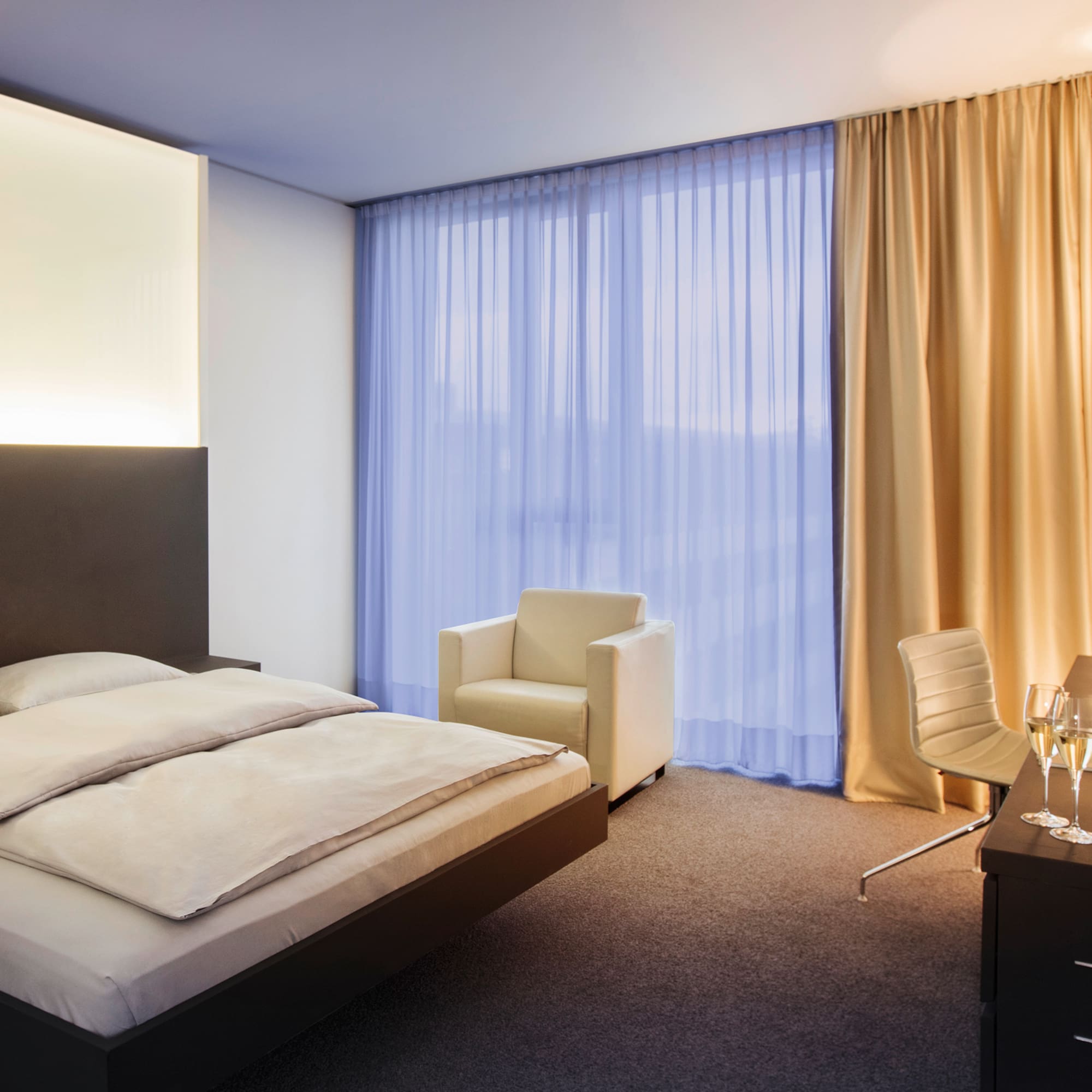 a bedroom with a bed and chair