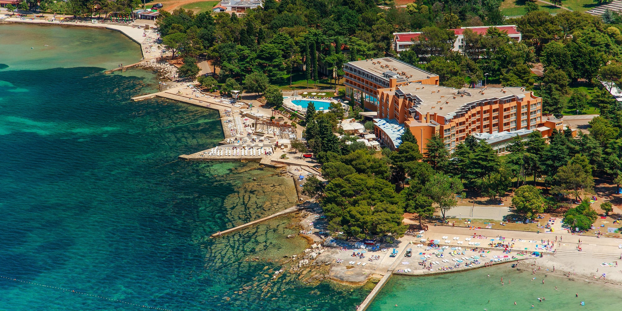a beach with a building and trees