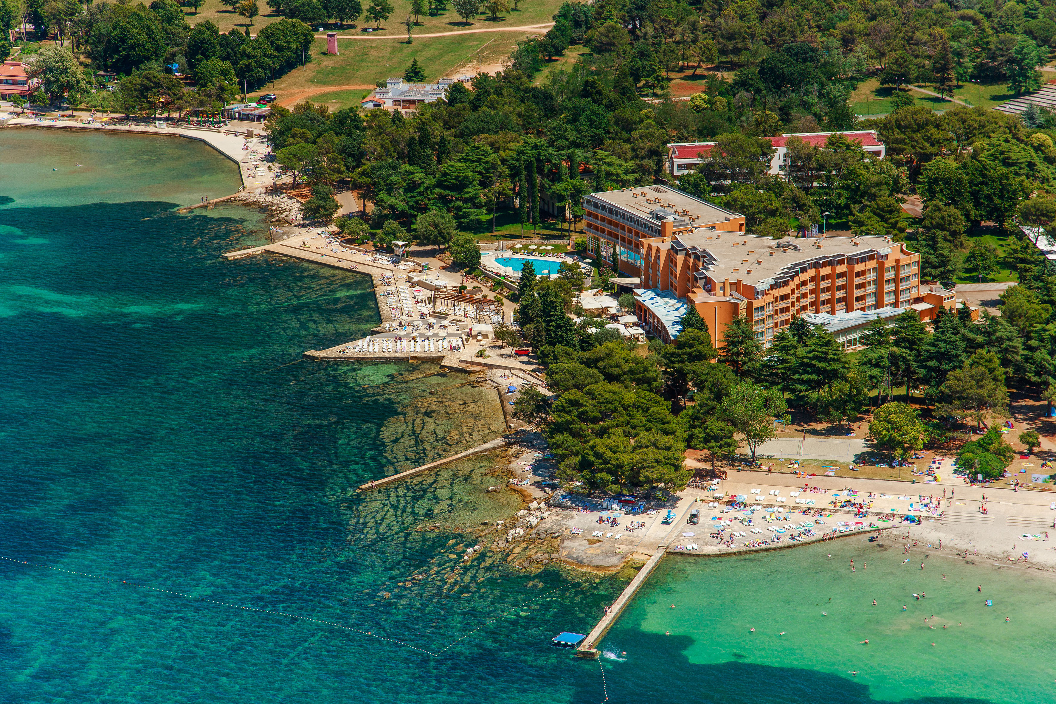 a beach with a building and trees