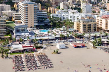 a beach with many buildings and a city