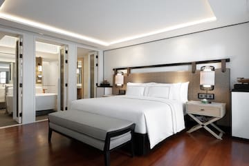 a bedroom with a bed and a bathtub