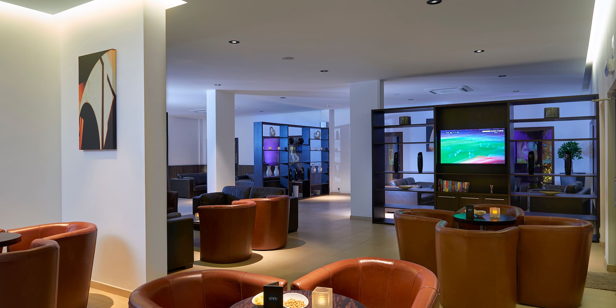 a room with a television and chairs