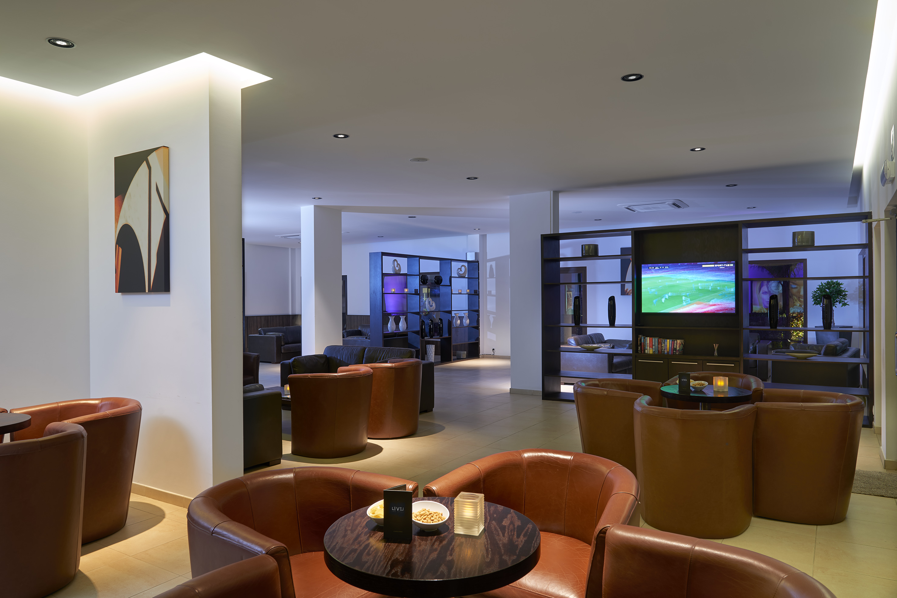 a room with a television and chairs