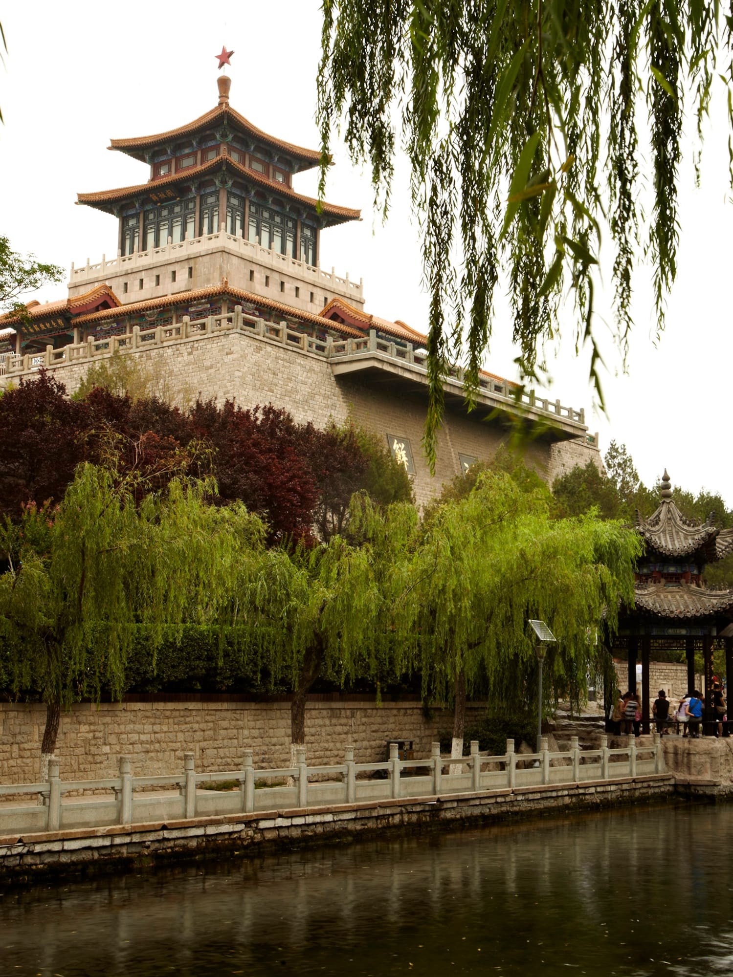 a building with a pagoda and a body of water