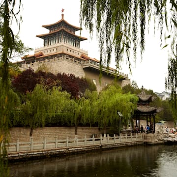 a building with a pagoda and a body of water