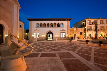 a courtyard with buildings and lights