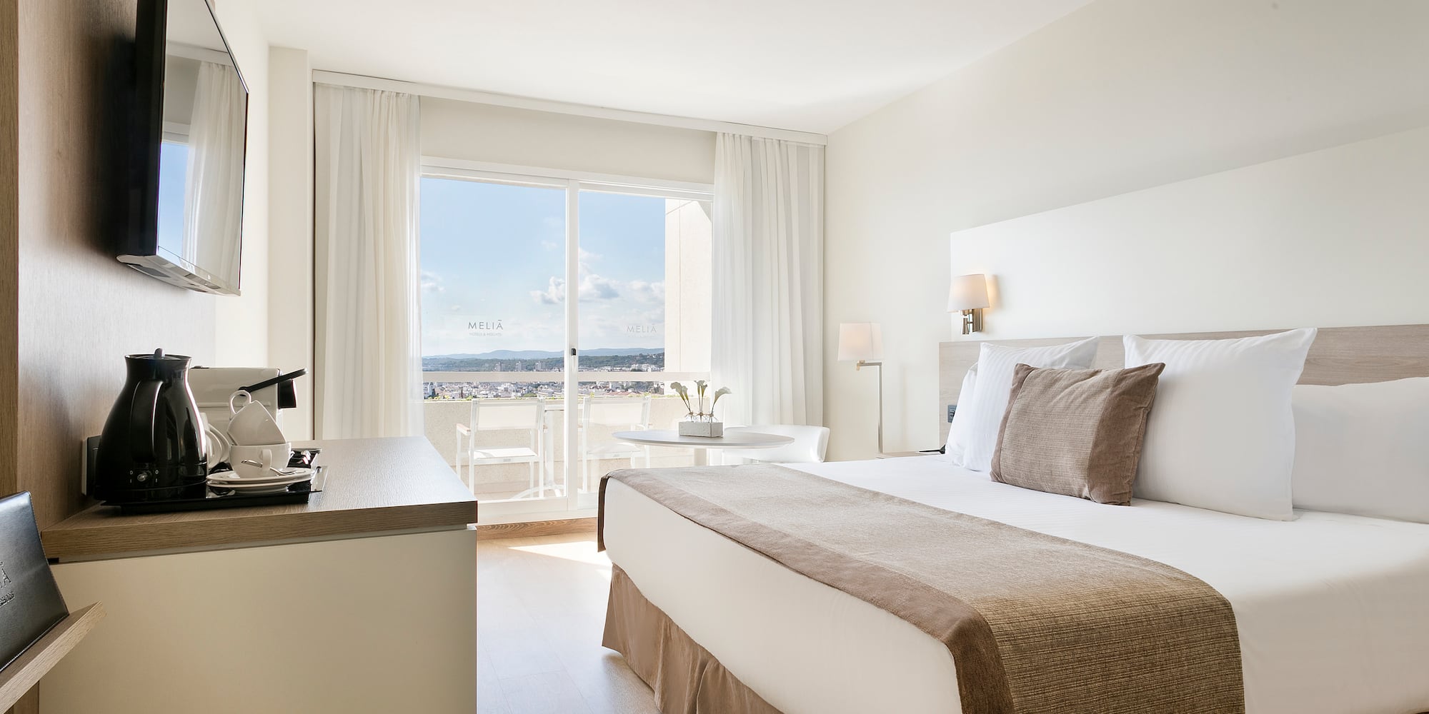 a bedroom with a large bed and a desk