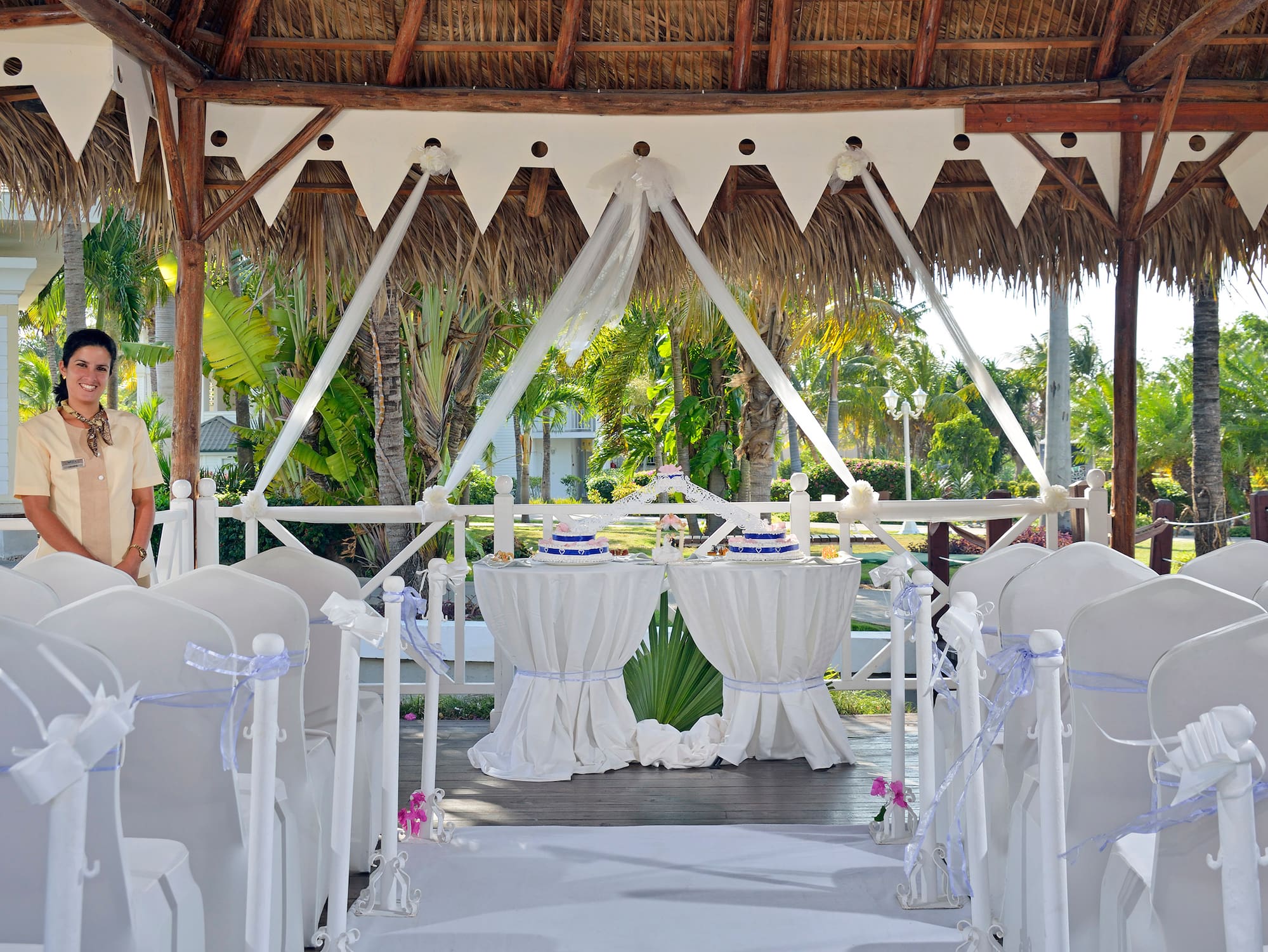 a wedding set up under a thatched roof