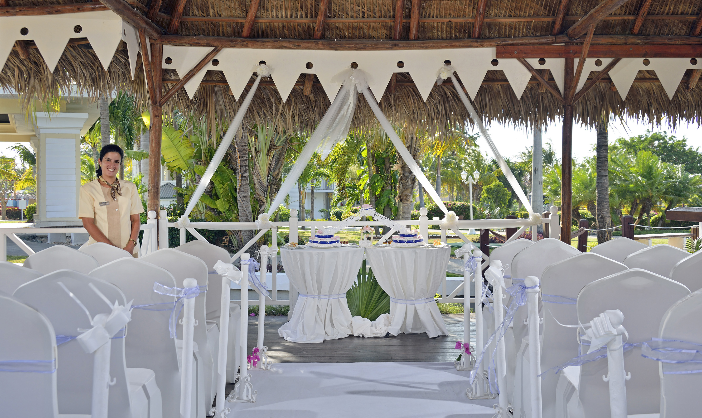 a wedding set up under a thatched roof