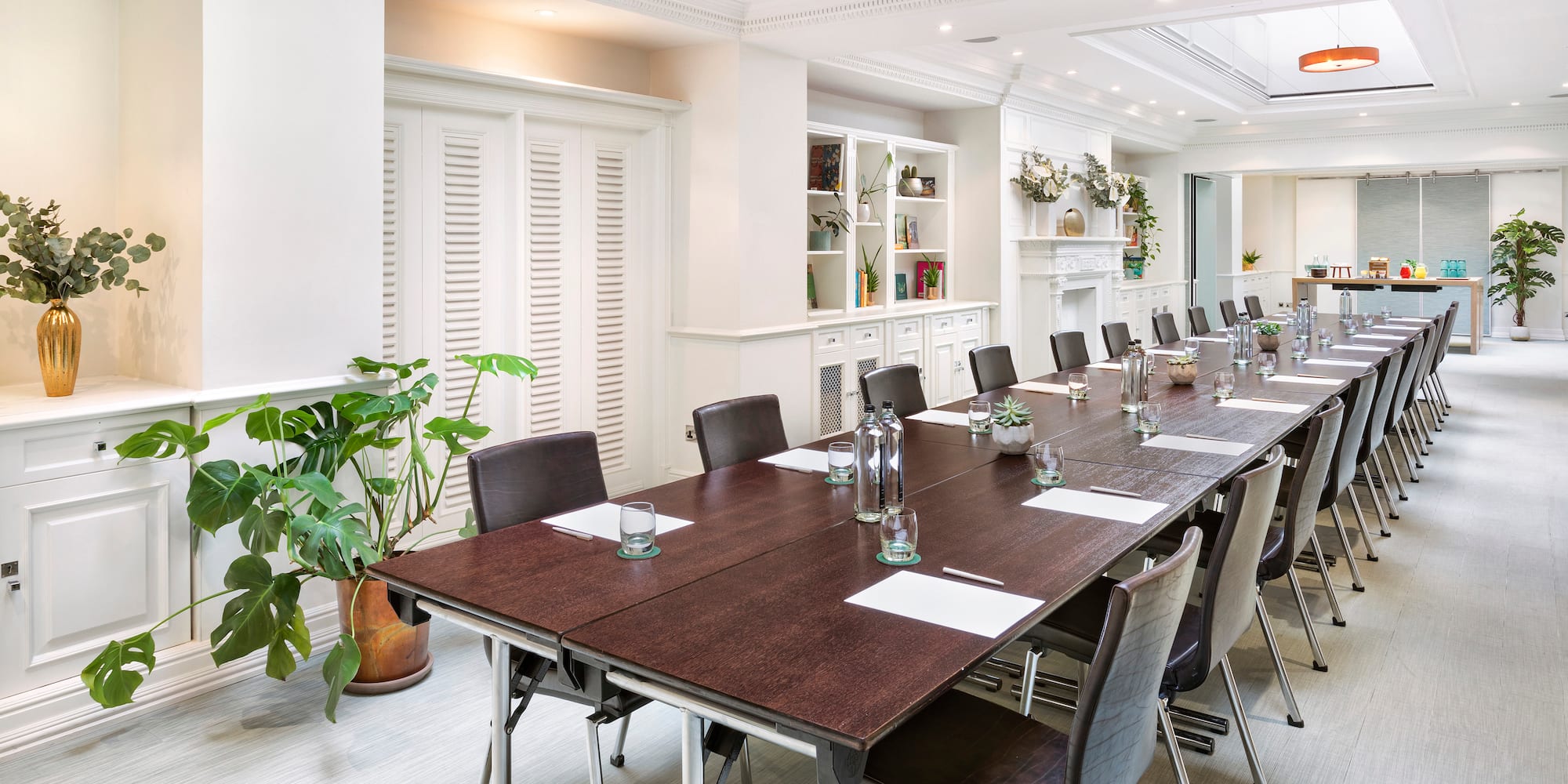 a long conference room with chairs and tables