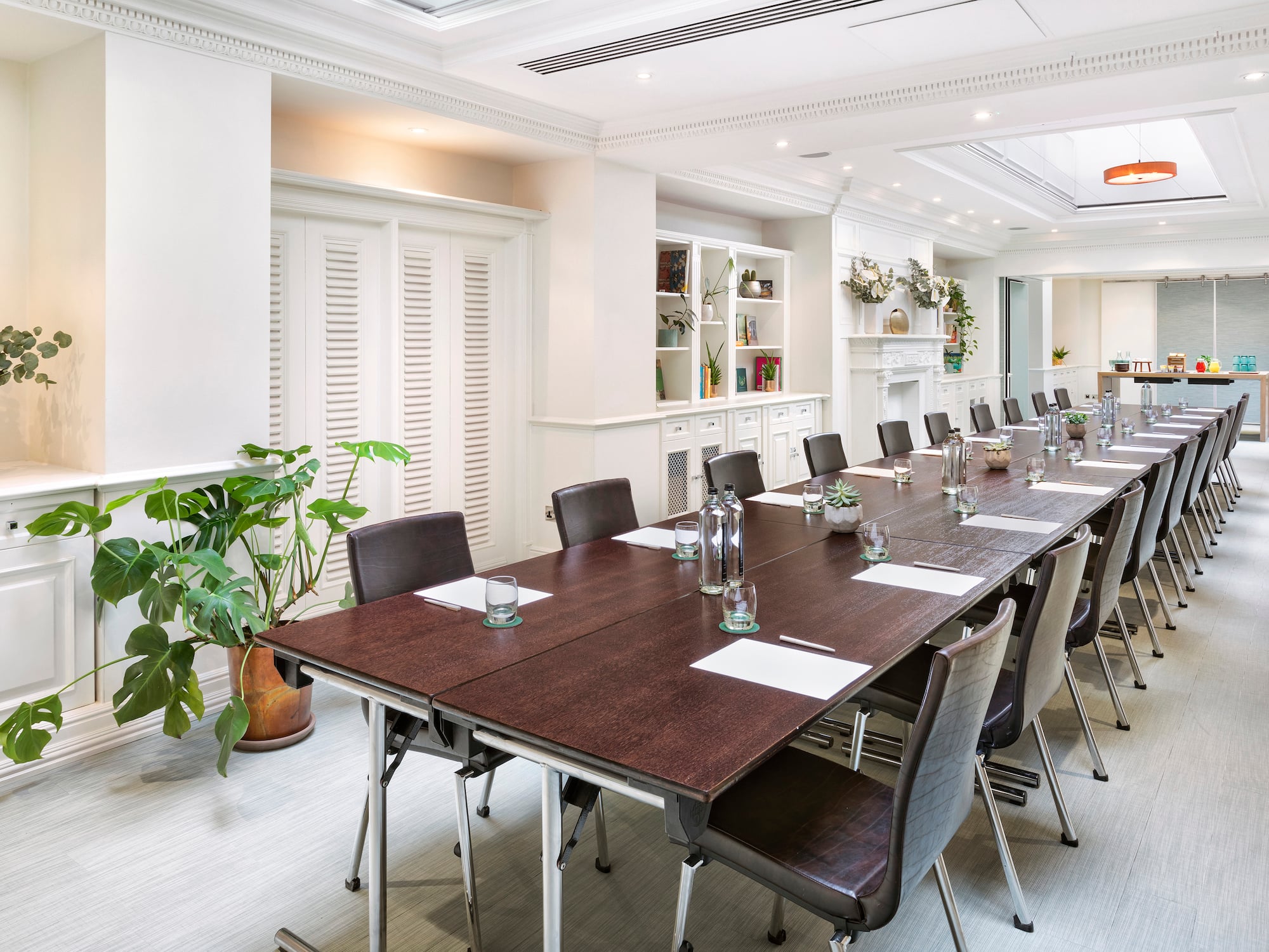 a long conference room with chairs and tables