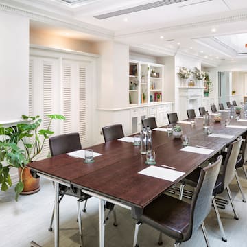 a long conference room with chairs and tables