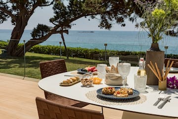 a table with food on it and a glass of wine on it